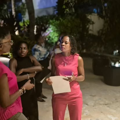 Woman in pink presenting at a CIWiL AB outdoor event.