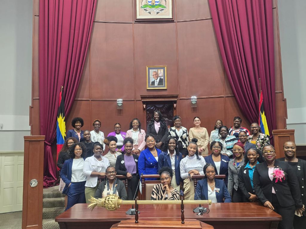 YWiL AB 2026 cohort full group photo inside the Antigua and Barbuda Parliament chamber