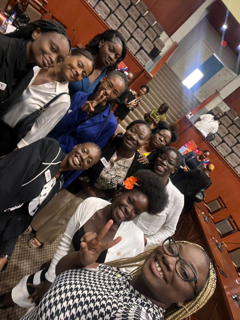 YWiL AB members group selfie with peace signs inside parliament